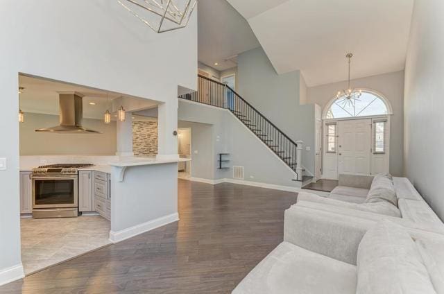 2716 Burton Dr, Westchester, IL 60154 - living area with a chandelier, high vaulted ceiling, wood finished floors, and stairway