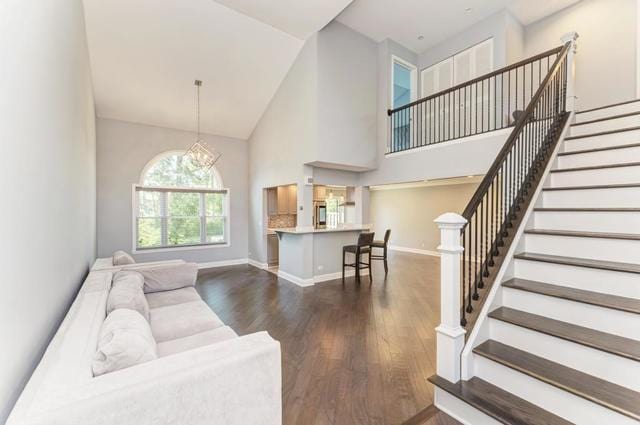 2716 Burton Dr, Westchester, IL 60154 - living area featuring high vaulted ceiling, wood finished floors, stairs, and a chandelier