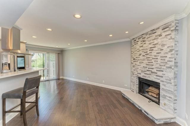 2716 Burton Dr, Westchester, IL 60154 - unfurnished living room featuring a stone fireplace, ornamental molding, dark wood-style flooring, and recessed lighting