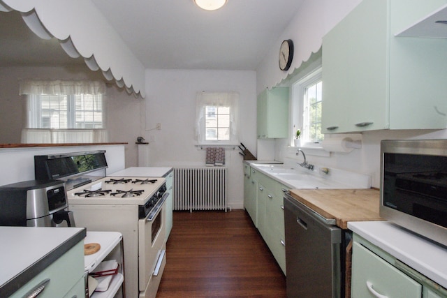 312 Home Ave, Oak Park, IL 60302 - kitchen with white range with gas cooktop, radiator heating unit, stainless steel microwave, dark wood-style flooring, and light countertops