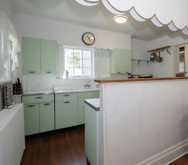 312 Home Ave, Oak Park, IL 60302 - kitchen featuring green cabinetry, light countertops, and dark wood-style floors