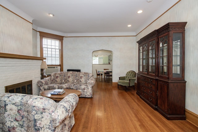 312 Home Ave, Oak Park, IL 60302 - living room with wood finished floors, arched walkways, a brick fireplace, and recessed lighting
