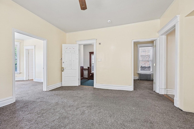 6225 S Wood St, Chicago, IL 60636 - unfurnished bedroom featuring radiator heating unit, carpet flooring, and multiple windows