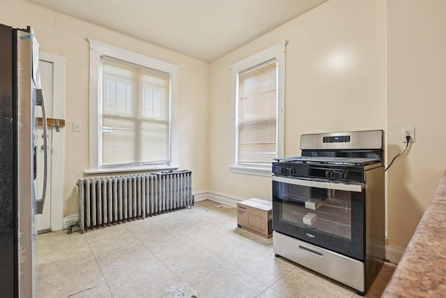 6225 S Wood St, Chicago, IL 60636 - kitchen with radiator heating unit, stainless steel appliances, light tile patterned flooring, and light countertops
