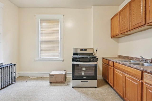 6225 S Wood St, Chicago, IL 60636 - kitchen featuring gas stove, light tile patterned floors, and brown cabinets
