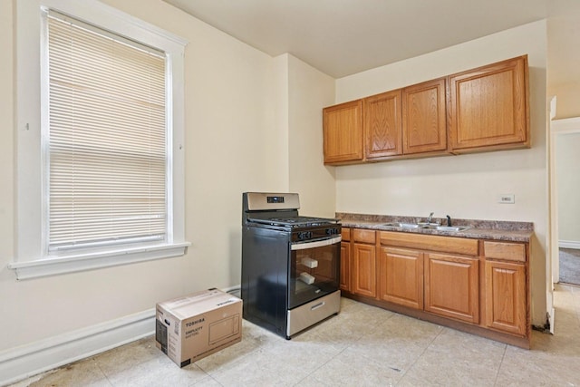 6225 S Wood St, Chicago, IL 60636 - kitchen with stainless steel range with gas cooktop, brown cabinets, and light tile patterned floors
