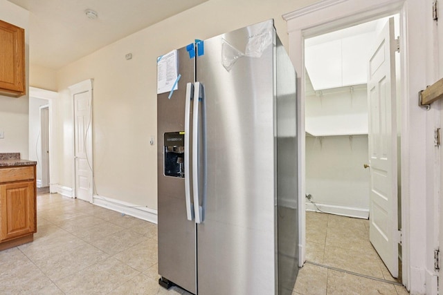 6225 S Wood St, Chicago, IL 60636 - kitchen with stainless steel refrigerator with ice dispenser, light tile patterned floors, and brown cabinets