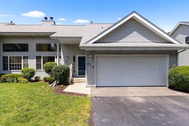818 Metz Ln, Rockton, IL 61072 - view of front of house featuring driveway, a front yard, an attached garage, a shingled roof, and a chimney