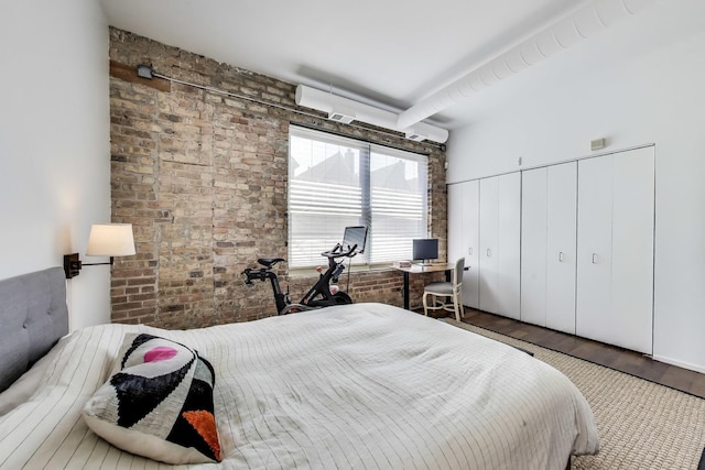 1720 N Marshfield Ave Unit 108, Chicago, IL 60622 - bedroom with wood finished floors and brick wall