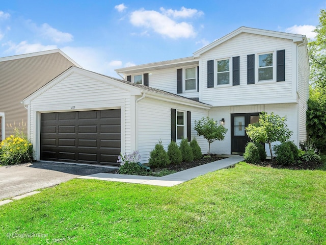 865 W Bryn Mawr Ave, Roselle, IL 60172 - view of front of home featuring driveway, a garage, and a front yard