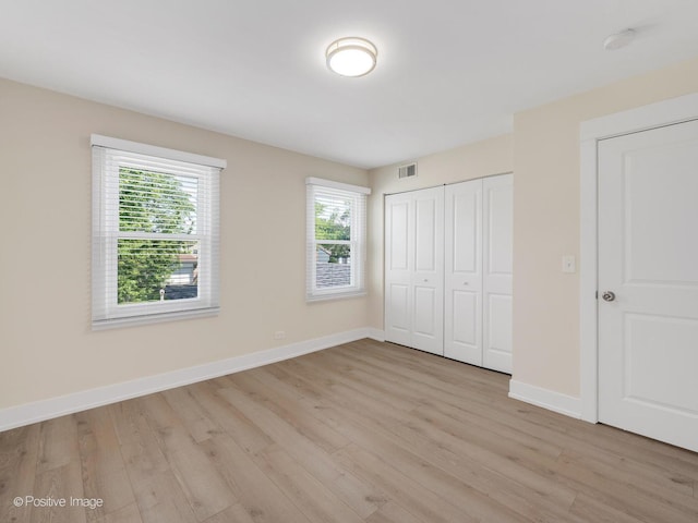 865 W Bryn Mawr Ave, Roselle, IL 60172 - unfurnished bedroom with light wood finished floors and a closet