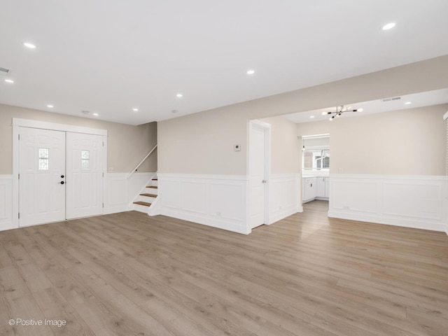 865 W Bryn Mawr Ave, Roselle, IL 60172 - unfurnished living room featuring a decorative wall, light wood-type flooring, stairs, wainscoting, and recessed lighting