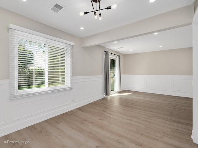 865 W Bryn Mawr Ave, Roselle, IL 60172 - unfurnished room featuring a chandelier, a wainscoted wall, light wood finished floors, recessed lighting, and a decorative wall