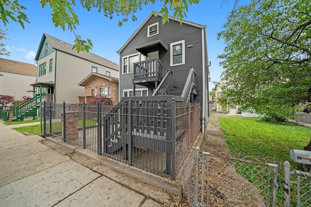 4532 S Laflin St, Chicago, IL 60609 - rear view of house with a fenced front yard, a balcony, stairs, and a gate