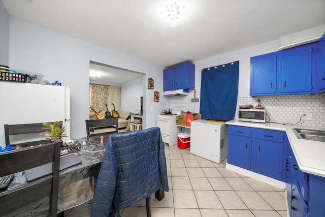 4532 S Laflin St, Chicago, IL 60609 - kitchen with white appliances, blue cabinetry, light countertops, and tasteful backsplash