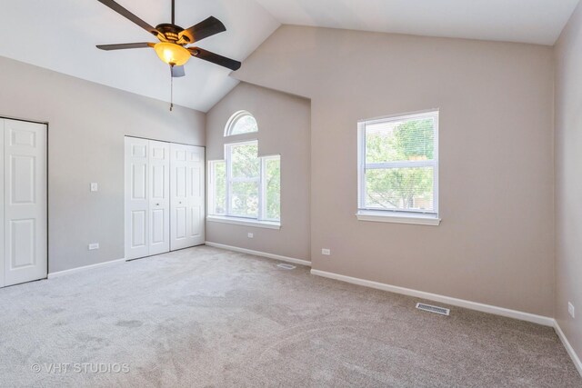 1109 Blackburn Dr, Grayslake, IL 60030 - unfurnished bedroom with multiple closets, carpet floors, high vaulted ceiling, and a ceiling fan