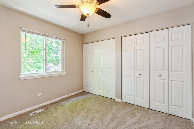 1109 Blackburn Dr, Grayslake, IL 60030 - unfurnished bedroom featuring carpet floors, two closets, and ceiling fan