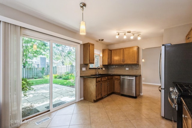1109 Blackburn Dr, Grayslake, IL 60030 - kitchen featuring stainless steel appliances, dark countertops, decorative backsplash, and brown cabinets