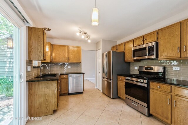 1109 Blackburn Dr, Grayslake, IL 60030 - kitchen with stainless steel appliances, backsplash, light tile patterned flooring, and brown cabinetry