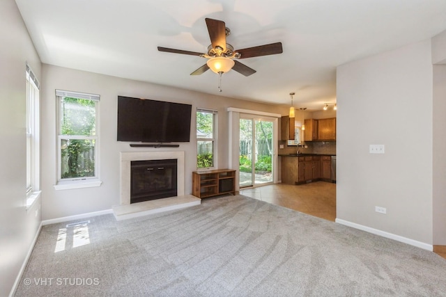 1109 Blackburn Dr, Grayslake, IL 60030 - living area featuring a glass covered fireplace, light carpet, and ceiling fan