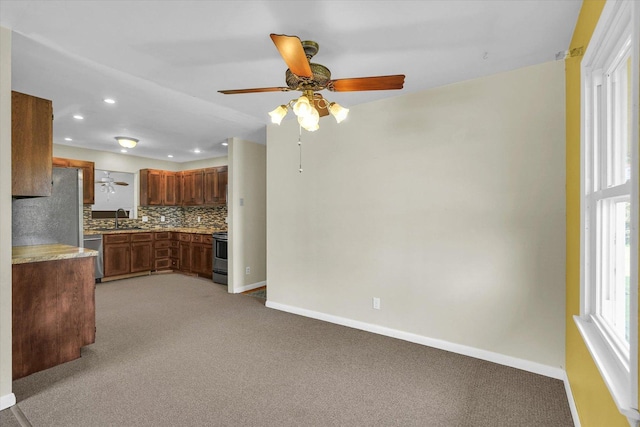 203 E Wilson, Tuscola, IL 61953 - kitchen with stainless steel appliances, a ceiling fan, light colored carpet, decorative backsplash, and recessed lighting