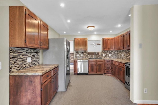 203 E Wilson, Tuscola, IL 61953 - kitchen with appliances with stainless steel finishes, decorative backsplash, recessed lighting, and brown cabinetry