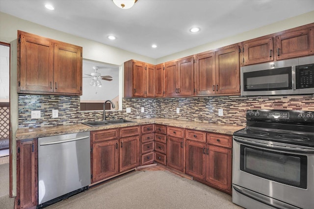 203 E Wilson, Tuscola, IL 61953 - kitchen featuring appliances with stainless steel finishes, a ceiling fan, decorative backsplash, recessed lighting, and light stone counters