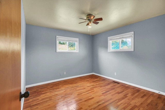 203 E Wilson, Tuscola, IL 61953 - empty room featuring healthy amount of natural light, ceiling fan, and wood finished floors