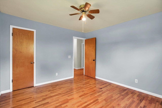 203 E Wilson, Tuscola, IL 61953 - unfurnished bedroom featuring light wood-style floors and a ceiling fan