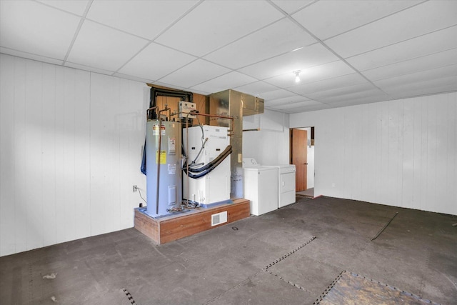 203 E Wilson, Tuscola, IL 61953 - below grade area with water heater, washing machine and dryer, a paneled ceiling, heating unit, and wood walls
