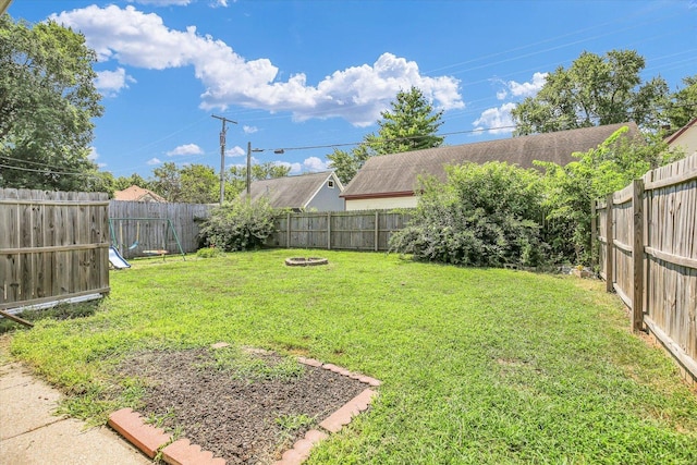 203 E Wilson, Tuscola, IL 61953 - fenced backyard with a fire pit