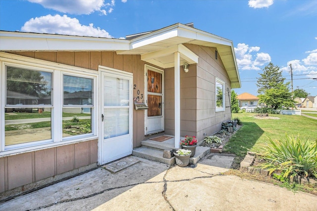 203 E Wilson, Tuscola, IL 61953 - property entrance featuring a yard and board and batten siding