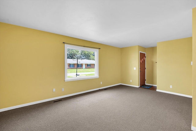 203 E Wilson, Tuscola, IL 61953 - spare room featuring baseboards and carpet