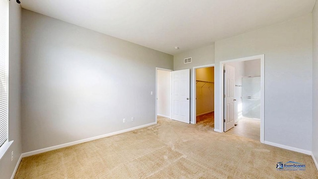 2215 Truman Trl, Mchenry, IL 60051 - unfurnished bedroom with light carpet, a walk in closet, and a closet