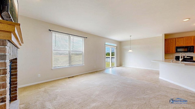2215 Truman Trl, Mchenry, IL 60051 - unfurnished living room with a fireplace, light colored carpet, and recessed lighting