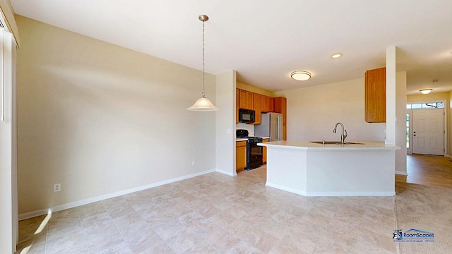 2215 Truman Trl, Mchenry, IL 60051 - kitchen with black appliances, brown cabinetry, hanging light fixtures, light countertops, and a peninsula