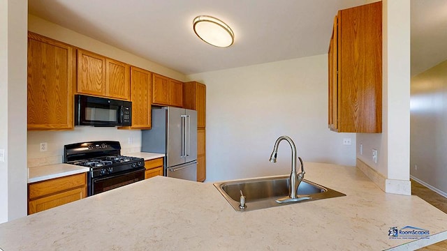 2215 Truman Trl, Mchenry, IL 60051 - kitchen featuring black appliances, brown cabinetry, light countertops, and a peninsula