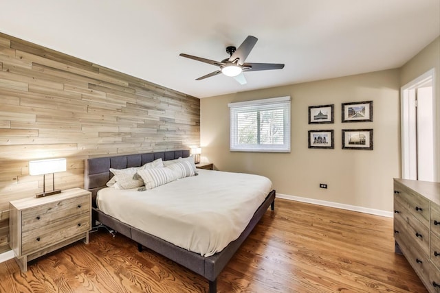 141 S Cedar St, Palatine, IL 60067 - bedroom featuring wood finished floors, a ceiling fan, an accent wall, and wood walls