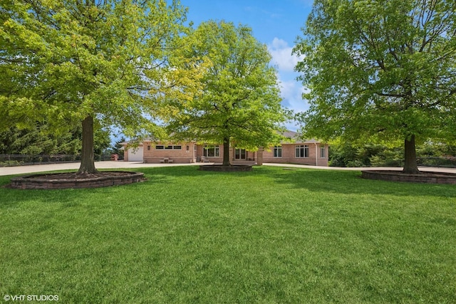 26 Red Hawk Dr, Oswego, IL 60543 - view of grassy yard featuring concrete driveway and a garage