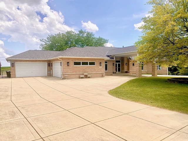 26 Red Hawk Dr, Oswego, IL 60543 - ranch-style house featuring brick siding, a front lawn, an attached garage, concrete driveway, and a shingled roof