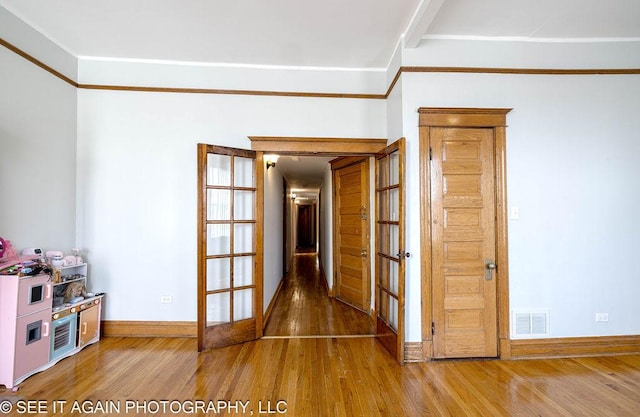 5942 S Calumet Ave, Chicago, IL 60637 - spare room with wood finished floors, french doors, and crown molding