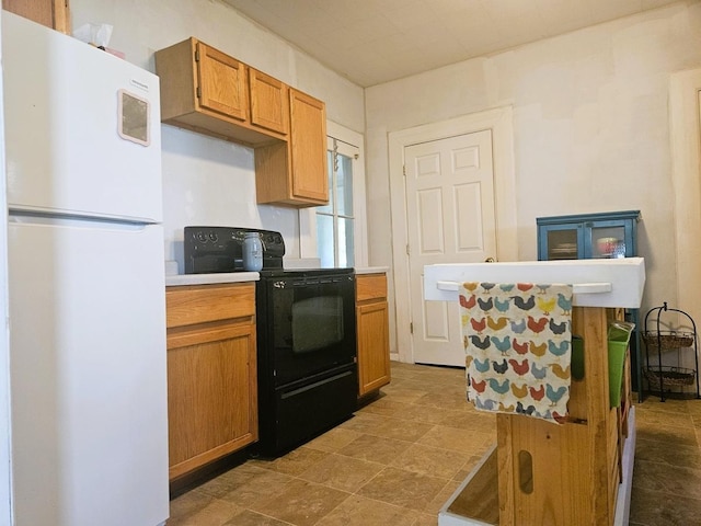 611 S Dixon Ave, Dixon, IL 61021 - kitchen with freestanding refrigerator, black electric range oven, light countertops, and brown cabinetry