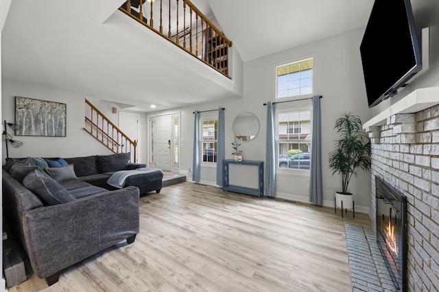 16026 85th Pl, Tinley Park, IL 60487 - living area with stairs, wood finished floors, a high ceiling, and a fireplace