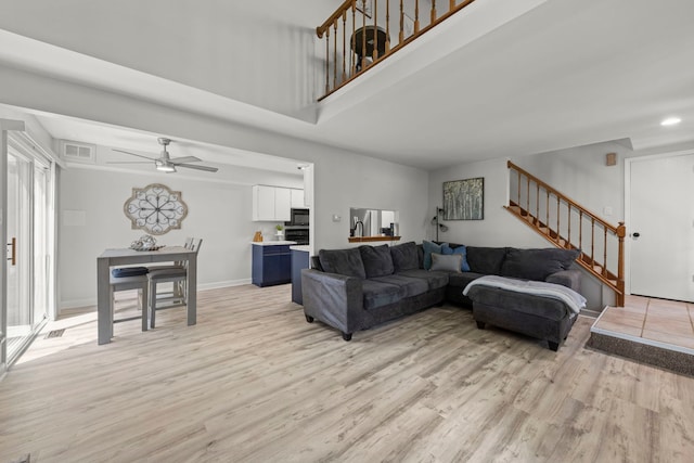 16026 85th Pl, Tinley Park, IL 60487 - living area with stairs, light wood-style floors, ceiling fan, a high ceiling, and recessed lighting
