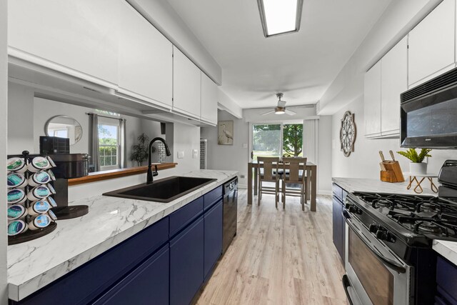16026 85th Pl, Tinley Park, IL 60487 - kitchen with black appliances, blue cabinetry, white cabinetry, and ceiling fan