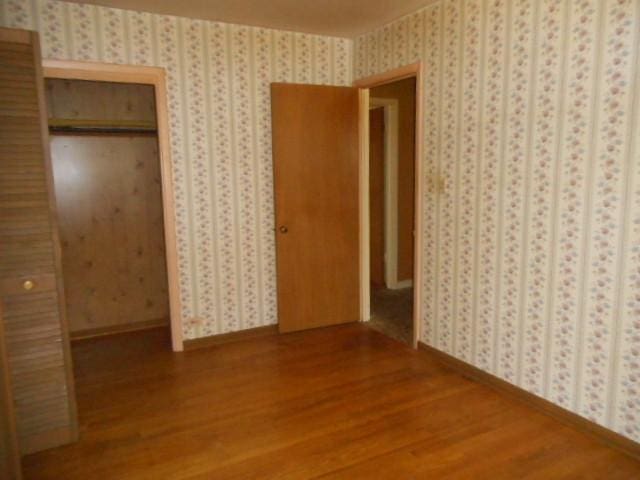 219 N Wilke Rd, Arlington Heights, IL 60005 - unfurnished bedroom featuring wood finished floors and a closet