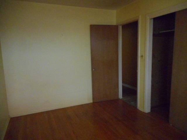 219 N Wilke Rd, Arlington Heights, IL 60005 - unfurnished bedroom with wood finished floors and a closet