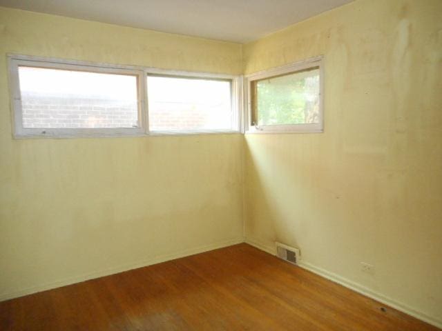 219 N Wilke Rd, Arlington Heights, IL 60005 - unfurnished room featuring wood finished floors and baseboards