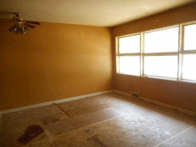 219 N Wilke Rd, Arlington Heights, IL 60005 - unfurnished room with baseboards and a ceiling fan