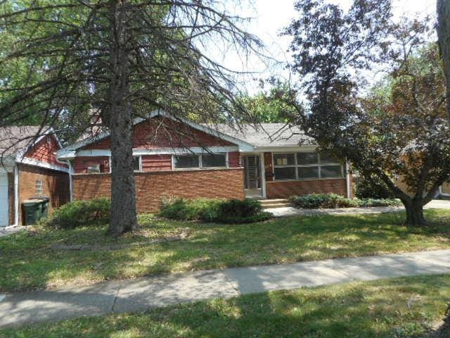 219 N Wilke Rd, Arlington Heights, IL 60005 - ranch-style house featuring brick siding, a front yard, and a garage